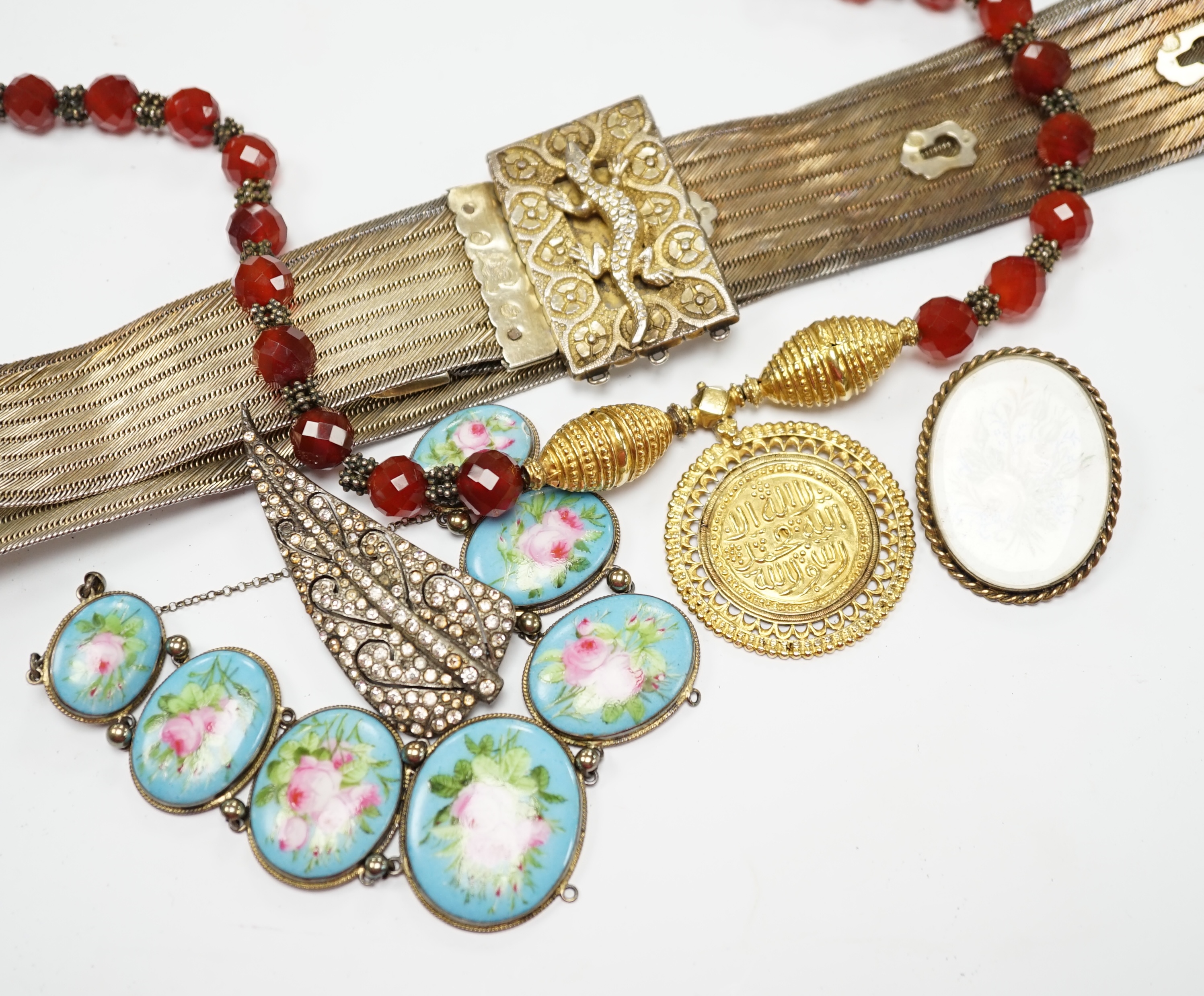 A group of assorted jewellery, including a Persian gilt white metal belt and a French gilt white metal and graduated porcelain plaque set bracelet. Fair condition.